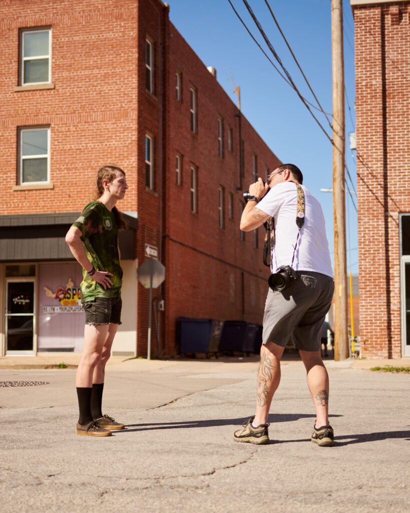 Erik Mathy shoots a portrait of Robin Cummings on Main Street Stillwater, OK