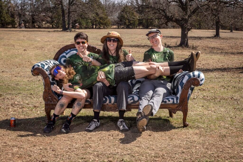 All four members of Nine Lives Cycling Collective pose on the Salsa Cycles Chaise at MidSouth 2026